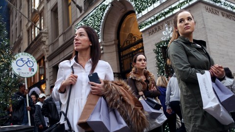 NEW YORK - NOVEMBER 27: Shoppers walk by holiday decor hanging on Harry Winston in New York City on Black Friday, November 27, 2015. Although Black Friday sales are expected to be strong, many shoppers are opting to buy online or retailers are offering year round sales and other incentives that are expected to ease crowds. (Photo by Yana Paskova/Getty Images)