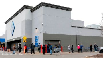 People line up outside of Sam's Club in Southfield, Michigan on March 30, 2020. (Photo by JEFF KOWALSKY / AFP) (Photo by JEFF KOWALSKY/AFP via Getty Images)
