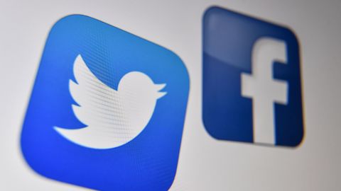 A photo taken on October 21, 2020 shows the logo of the the American online social media and social networking service, Facebook and Twitter on a computer screen in Lille. (Photo by Denis Charlet / AFP) (Photo by DENIS CHARLET/AFP via Getty Images)
