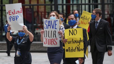 Airline industry workers hold signs during a protest in Federal Plaza in Chicago, Illinois, on September 9, 2020. - Other protests where held in Washington, DC outside the US Capitol, organized by the Association of Flight Attendants urging the US Congress to pass a Covid-19 relief package and extend the Paycheck Support Program to save aviation jobs. (Photo by KAMIL KRZACZYNSKI / AFP) (Photo by KAMIL KRZACZYNSKI/AFP via Getty Images)