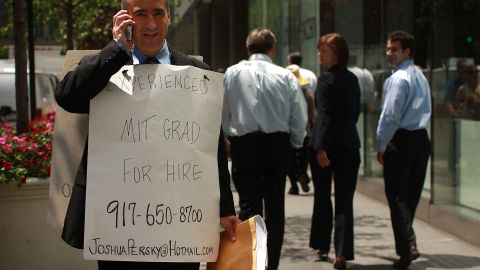 NEW YORK - JUNE 24: Joshua Persky, an unemployed financial engineer, stands in front of the Charles Schwab building at 50th Street and Park Avenue with a sign proclaiming "Experienced MIT Graduate for Hire" June 24, 2008 in New York City.  Persky, who lost his job in the volatile banking industry six months ago, thought standing on a corner passing out resumes would be a novel approach over networking and writing emails at home. Persky is married and supports five children.  (Photo by Spencer Platt/Getty Images)