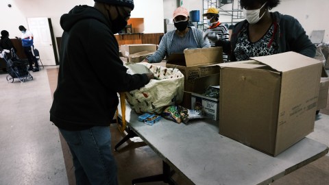 NEW YORK, NEW YORK - OCTOBER 17: People receive food at a distribution site at a Bronx church on on October 17, 2020 in New York City. The Bronx, a borough which has long struggled with poverty and neglect, has been especially impacted by the COVID-19 pandemic. The official unemployment rate in the Bronx is 21% while the unofficial number is presumed to be almost twice that. With many residents unable to afford health care and being home to a significant amount of front-line workers, the Bronx has the highest COVID-19 death rate in New York City. (Photo by Spencer Platt/Getty Images)