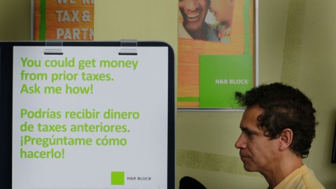 MIAMI BEACH, FL - APRIL 14:  Diego Sanclemente sits with S. Pieto Tondini, an H&R Block Tax Associate, as they work on completing his tax form the day before the Internal Revenue Service deadline on April 14, 2010 in Miami Beach, Florida.  With only one day to go before the April 15th deadline to file taxes, accountants around the U.S. are swamped with people who waited until the last day to file.  (Photo by Joe Raedle/Getty Images)
