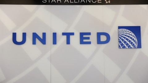 A United Airlines logo is seen behind the ticket counter at Chicago's O'Hare airport on August 13, 2013. The US Justice Department and several states sued Tuesday to block the $11 billion merger between American Airlines and US Airways, saying it would reduce competition and push up fares. AFP PHOTO / Mira OBERMAN (Photo credit should read MIRA OBERMAN/AFP via Getty Images)