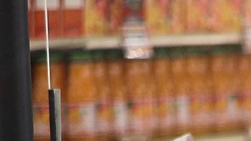 MIAMI, FLORIDA - APRIL 13: Diana Rivero stands behind a partial protective plastic screen and wears a mask and gloves as she works as a cashier at the Presidente Supermarket on April 13, 2020 in Miami, Florida. The employees at Presidente Supermarket, like the rest of America's grocery store workers, are on the front lines of the coronavirus pandemic, helping to keep the nation's residents fed. (Photo by Joe Raedle/Getty Images)