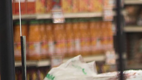 MIAMI, FLORIDA - APRIL 13: Diana Rivero stands behind a partial protective plastic screen and wears a mask and gloves as she works as a cashier at the Presidente Supermarket on April 13, 2020 in Miami, Florida. The employees at Presidente Supermarket, like the rest of America's grocery store workers, are on the front lines of the coronavirus pandemic, helping to keep the nation's residents fed. (Photo by Joe Raedle/Getty Images)