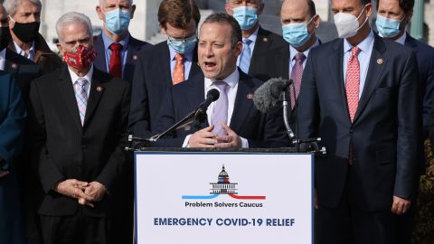 WASHINGTON, DC - DECEMBER 03: Rep. Josh Gottheimer (D-NJ) (C) and Rep. Tom Reed (R-NY) (3rd R), co-chairs of the bipartisan Problem Solvers Caucus, hold a news conference with fellow members of Congress to highlight the need for bipartisan, bicameral COVID-19 relief legislation outside the U.S. Capitol on December 03, 2020 in Washington, DC. With the holiday season approaching and the legislative session coming to a close, federal government funding for critical coronavirus relief programs is set to expire as the U.S. faces daily records for infections, hospitalizations, and deaths. (Photo by Chip Somodevilla/Getty Images)
