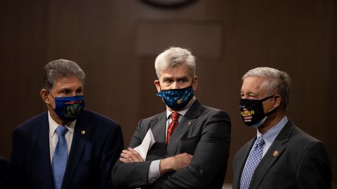 WASHINGTON, DC - DECEMBER 01: Sen. Joe Manchin (D-WV), Sen. Bill Cassidy (R-LA) and Rep. Fred Upton (R-MI) stand alongside a bipartisan group of Democrat and Republican members of Congress as they announce a proposal for a Covid-19 relief bill on Capitol Hill on December 01, 2020 in Washington, DC. The roughly $908 billion proposal includes $288 billion in small business aid such as Paycheck Protection Program loans, $160 billion in state and local government relief and $180 billion to fund a $300 per week supplemental unemployment benefit through March, according to a draft framework. (Photo by Tasos Katopodis/Getty Images)