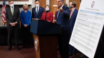 US Senator Joe Manchin (C), Democrat of West Virginia, speaks alongside a bipartisan group of Democrat and Republican members of Congress as they announce a proposal for a Covid-19 relief bill on Capitol Hill in Washington, DC, on December 1, 2020.