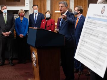 US Senator Joe Manchin (C), Democrat of West Virginia, speaks alongside a bipartisan group of Democrat and Republican members of Congress as they announce a proposal for a Covid-19 relief bill on Capitol Hill in Washington, DC, on December 1, 2020.