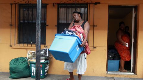 MIAMI - JUNE 15:  Brandy Young carries some of her belongings from her apartment before officials arrived to empty her apartment and change the locks during an eviction on June 15, 2010 in Miami, Florida. A small protest organized by Take Back the Land tried to prevent the eviction but it was unsuccessful. According to the activists, the bank, which now owns the apartment complex, is forcing the current residents out and they have no other homes to move to.  (Photo by Joe Raedle/Getty Images)