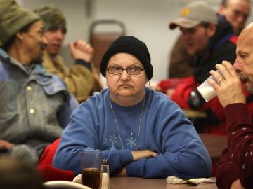 WILMINGTON, OH - JANUARY 29: People wait to be served at the Sugartree Ministries soup kitchen January 29, 2009 in Wilmington, Ohio. The center has begun serving increased numbers of people, as layoffs in the town skyrocket. The German air shipping company DHL closed down its U.S. domestic shipping service and thousands of job losses in its Wilmington hub are devastating the local economy. (Photo by John Moore/Getty Images)