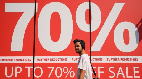 LONDON, UNITED KINGDOM - AUGUST 12: A person walks past one of the many sale signs displayed in store windows on Oxford Street on August 12, 2020 in London, United Kingdom. The Office For National Statistics (ONS) reported the UK's GDP fell By 20.4% between April and June 2020.  The UK economy suffered its biggest slump on record due to the coronavirus lockdown measures pushing the country into recession. (Photo by Leon Neal/Getty Images)