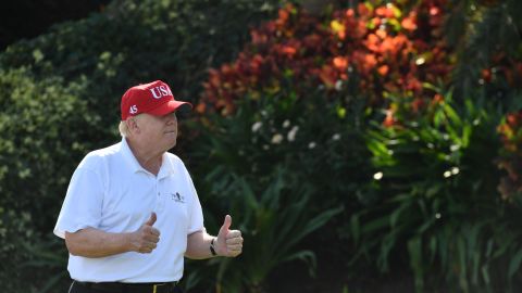 US President Donald Trump holds two thumbs up while meeting with service members of the United States Coast Guard to play golf at Trump International Golf Course in Mar-a-Lago, Florida on December 29, 2017.
The President invited members of the Coast Guard to play golf to thank them personally for their service of patrolling the waters near Palm Beach and Mar-a-Lago. / AFP PHOTO / Nicholas Kamm (Photo credit should read NICHOLAS KAMM/AFP via Getty Images)