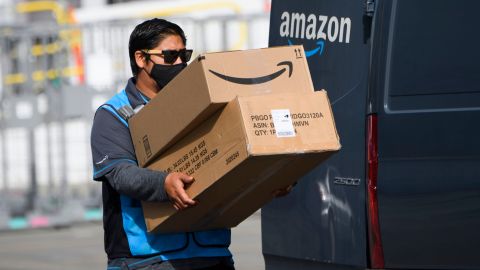 An Amazon.com Inc. delivery driver carries boxes into a van outside of a distribution facility on February 2, 2021 in Hawthorne, California. - Jeff Bezos said February 1, 2021, he would give up his role as chief executive of Amazon later this year as the tech and e-commerce giant reported a surge in profit and revenue in the holiday quarter. The announcement came as Amazon reported a blowout holiday quarter with profits more than doubling to $7.2 billion and revenue jumping 44 percent to $125.6 billion. (Photo by Patrick T. FALLON / AFP) (Photo by PATRICK T. FALLON/AFP via Getty Images)