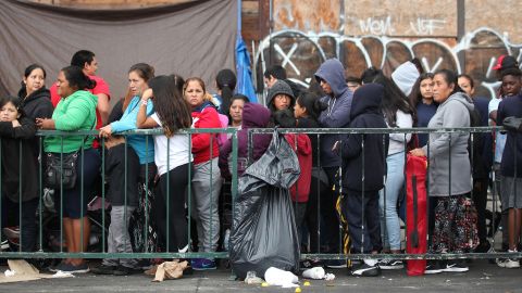 LOS ANGELES, CALIFORNIA - SEPTEMBER 28: People wait in line to receive new school supplies, including new athletic shoes donated by Foot Locker, at Fred Jordan Missions on Skid Row, on September 28, 2019 in Los Angeles, California. Fred Jordan Missions, which feeds over 100 people experiencing homelessness daily, hosts the annual event with Foot Locker. They donated new sneakers and other school supplies to more than 3,000 underprivileged and homeless children at the event this year. (Photo by Mario Tama/Getty Images)