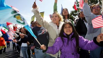 COSTA MESA, CA - APRIL 01:  Seven-year-old April Palazios, whose parents came from Guatemala, waves Guatemalan and US flags as protesters march to decry pending federal legislation aimed at reducing illegal immigration on April 1, 2006 in Costa Mesa, California. An estimated 1,500 to 2,000 people participated in today's demonstration including members of the Mexican American Political Association, Hermandad Mexicana Latino Americana, and Service Employees International Union participated in the rally.  (Photo by David McNew/Getty Images)