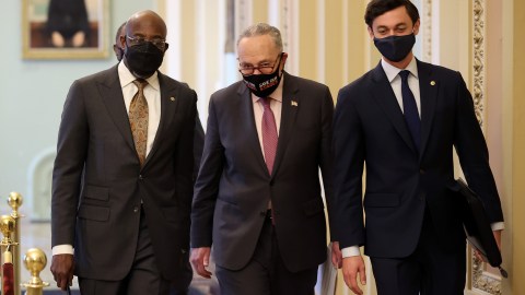 WASHINGTON, DC - FEBRUARY 11: Senate Majority Leader Charles Schumer (D-NY) (C) walks with Sen. Raphael Warnock (D-GA) (L) and Sen. Jon Ossoff (D-GA) on their way to a news conference at the U.S. Capitol on February 11, 2021 in Washington, DC. Schumer and the new senators from Georgia held the news conference to push for the Democratic coronavirus relief legislation. (Photo by Chip Somodevilla/Getty Images)