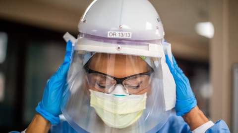 Registered nurse Carmen Verano wipes her CAPR helmet after attending a Covid-19 patient in the Intensive Care Unit (ICU) at Providence Cedars-Sinai Tarzana Medical Center in Tarzana, California on December 18, 2020. (Photo by Apu GOMES / AFP) (Photo by APU GOMES/AFP via Getty Images)