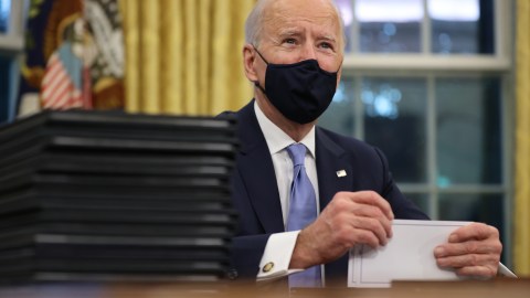 WASHINGTON, DC - JANUARY 20: U.S. President Joe Biden prepares to sign a series of executive orders at the Resolute Desk in the Oval Office just hours after his inauguration on January 20, 2021 in Washington, DC. Biden became the 46th president of the United States earlier today during the ceremony at the U.S. Capitol. (Photo by Chip Somodevilla/Getty Images)