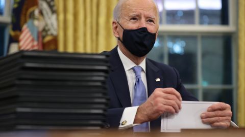 WASHINGTON, DC - JANUARY 20:  U.S. President Joe Biden prepares to sign a series of executive orders at the Resolute Desk in the Oval Office just hours after his inauguration on January 20, 2021 in Washington, DC. Biden became the 46th president of the United States earlier today during the ceremony at the U.S. Capitol.  (Photo by Chip Somodevilla/Getty Images)