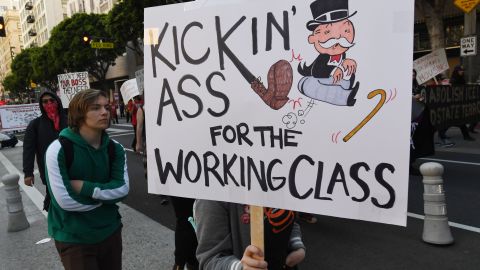 TOPSHOT - Union members, activists and their supporters march through the city during their annual May Day procession in support of workers' rights and immigrant freedom in Los Angeles on May 1, 2019. - May Day has been an international workers' celebration for more than 130 years. (Photo by Mark RALSTON / AFP)        (Photo credit should read MARK RALSTON/AFP via Getty Images)