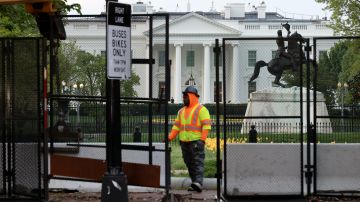 WASHINGTON, DC - APRIL 14: Workers remove or reconfigure sections of the fence surrounding the White House and nearby administration buildings on April 14, 2021 in Washington, DC. Some sections of the eight-foot-tall metal fencing that has surrounded the White House, the Treasury Department and other administration buildings since November of 2020 were removed in some places and adjusted and reinforced in others. (Photo by Chip Somodevilla/Getty Images)