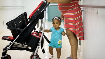 LOIZA, PUERTO RICO - AUGUST  30: Expectant mom Luz Solis, 22, waits in a hallway as her one year old daughter Josranely Matos walks by at the Concilio de Salud Integral in Loiza, a primary care health clinic,  on August 30, 2016 in Loiza, Puerto Rico. The Centres for Disease Control and Prevention has estimated that 25% of the Puerto Rico's population could have the Zika Virus by the end of mosquito season, and that up to 50 pregnant women each day are infected on the island.  A recent study projected as many as 270 babies could be born with the debilitating birth defect microcephaly, between now and mid-2017. In a normal year, doctors expect to see just 16 such cases.  (Photo by Angel Valentin/Getty Images)