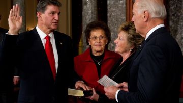 US Vice President Joe Biden (R) holds a ceremonial swearing-in of Senator Joe Manchin, a Democrat from West Virginia, in the Old Senate Chamber at the US Capitol in Washington on November 15, 2010. Holding the bible for the swearing-in is Manchin's mother Mary Manchin (2nd L) and his wife Gayle Manchin (2nd R).         AFP PHOTO / Saul LOEB (Photo credit should read SAUL LOEB/AFP via Getty Images)