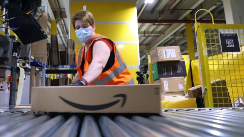 An employee prepares a package for shipment at the Amazon logistics centre in Suelzetal near Magdeburg, eastern Germany, on Mai 12, 2021. - The US online sales giant had opened the new warehouse in Saxony-Anhalt in August 2020. (Photo by Ronny Hartmann / AFP) (Photo by RONNY HARTMANN/AFP via Getty Images)