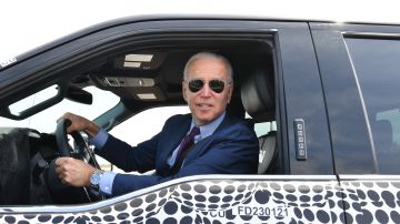 TOPSHOT - US President Joe Biden drives the new electric Ford F-150 Lightning at the Ford Dearborn Development Center in Dearborn, Michigan on May 18, 2021. (Photo by Nicholas Kamm / AFP) (Photo by NICHOLAS KAMM/AFP via Getty Images)