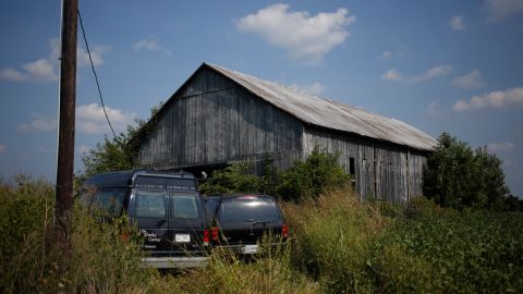 PLEASUREVILLE, KY - SEPTEMBER 9:  Vehicles driven by migrant workers from Mexico and Nicaragua are seen parked outside a tobacco barn September 9, 2013 in Pleasureville, Kentucky. The migrant workers participate in the U.S. Department of Labor's H-2A temporary agricultural program, which allows agricultural employers to hire temporary help for seasonal work. (Photo by Luke Sharrett/Getty Images)