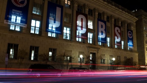 A banner reading "Jobs" hangs on thre facade of the US Chamber of Commerce in Washington on February 25, 2011. New claims for US unemployment insurance rose for the first time in three weeks but continued to hover near a two-year low, official data released on February 17 showed. The Labor Department said a seasonally adjusted 410,000 initial jobless claims were filed in the week ending February 12, up 6.5 percent from the prior week when claims had fallen to their lowest level since July 2008. AFP PHOTO/Nicholas KAMM (Photo credit should read NICHOLAS KAMM/AFP via Getty Images)