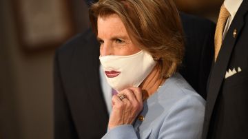 Senator Shelley Moore Capito, R-W.Va., shows her face mask as she participates in a mock swearing-in for the 117th Congress with Vice President Mike Pence in the Old Senate Chamber at the US Capitol in Washington, DC on January 3, 2021. (Photo by KEVIN DIETSCH / POOL / AFP) (Photo by KEVIN DIETSCH/POOL/AFP via Getty Images)