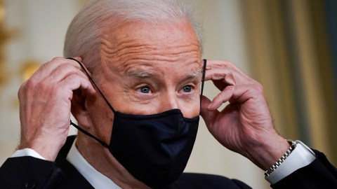 WASHINGTON, DC - MARCH 15: U.S. President Joe Biden puts on a face covering as he concludes his remarks in the State Dining Room of the White House on March 15, 2021 in Washington, DC. The administration announced on Monday that Gene Sperling, a former top economic official in the last two Democratic presidential administrations, will oversee the rollout of the $1.9 trillion coronavirus stimulus package that Biden signed into law last week. (Photo by Drew Angerer/Getty Images)