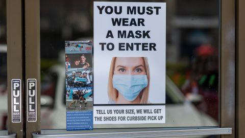 GLENDALE, CA - MAY 27: Masks are required for entry to a Shoe City store as Los Angeles County retail businesses reopen while the COVID-19 pandemic continues on May 27, 2020 in Glendale, Californias latest guidelines and allow the resumption of in-store shopping at low-risk retail stores, faith-based services, drive-in theaters and other recreational activities with reduced capacities and social distancing restrictions, starting today. Not reopening yet are personal services locations like hair salons and dining in at restaurants. (Photo by David McNew/Getty Images)
