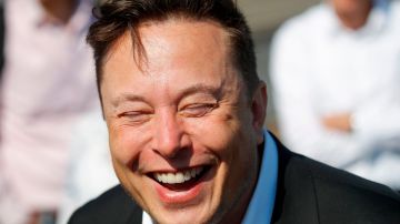 Tesla CEO Elon Musk laughs as he talks to media as he arrives to visit the construction site of the future US electric car giant Tesla, on September 03, 2020 in Gruenheide near Berlin. - Tesla builds a compound at the site in Gruenheide in Brandenburg for its first European "Gigafactory" near Berlin. (Photo by Odd ANDERSEN / AFP) (Photo by ODD ANDERSEN/AFP via Getty Images)