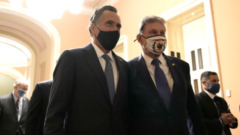 WASHINGTON, DC - APRIL 28: Sen. Mitt Romney (R-UT) and Sen. Joe Manchin (D-WV) walk through the Capitol Building before U.S. President Joe Biden addresses a joint session of congress in the House chamber of the U.S. Capitol April 28, 2021 in Washington, DC. On the eve of his 100th day in office, Biden spoke about his plan to revive America’s economy and health as it continues to recover from a devastating pandemic. He delivered his speech before 200 invited lawmakers and other government officials instead of the normal 1600 guests because of the ongoing COVID-19 pandemic. (Photo by Drew Angerer/Getty Images)