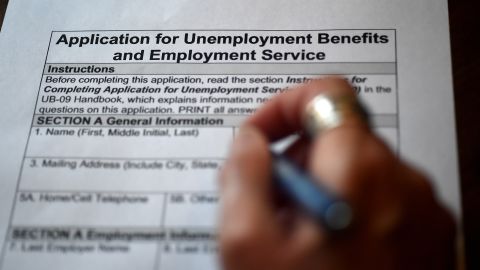 In this photo illustration, a person files an application for unemployment benefits on April 16, 2020, in Arlington, Virginia. - The government reported Thursday that another 5.2 million US workers filed for unemployment benefits, taking the four-week total to 22 million, a staggering figure in a downturn that economists say presents the country with its most severe outlook since the Great Depression of the 1930s. (Photo by Olivier DOULIERY / AFP) (Photo by OLIVIER DOULIERY/AFP via Getty Images)