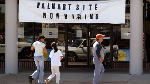 NILES, IL - AUGUST 15:  Pedestrians pass a hiring center for a new Wal-Mart store under construction August 15, 2006 in Niles, Illinois. Earlier this month, the Chicago City Council passed a bill that forces big-box retailers to pay at least $10 per hour to workers. Officials at retailers Wal-Mart, Lowe's and Target have said that the bill, which must still be signed by Mayor Richard Daley, could cause them to put plans for outlets in the Chicago area on hold. This new Wal-Mart store would be the second in Niles, a suburban border community north of Chicago.  (Photo by Tim Boyle/Getty Images)