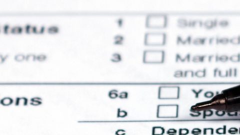 Bolígrafo negro sobre el formulario de impuestos W-8BEN.