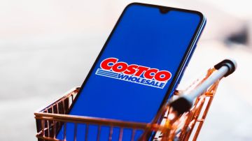 El logotipo de Costco Wholesale Corporation aparece en un teléfono inteligente junto con un carrito de compras.