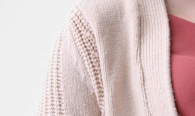 Mujer embarazada rodeada de dólares que caen del cielo, representando un cheque de estímulo.